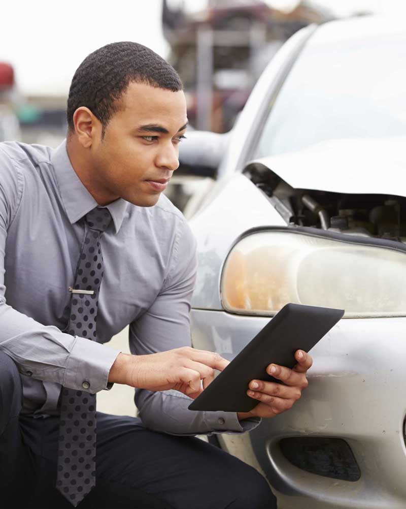 Insurance adjuster examining property damage.