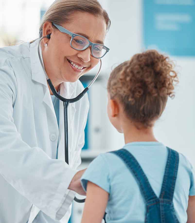 Health professional examining a child