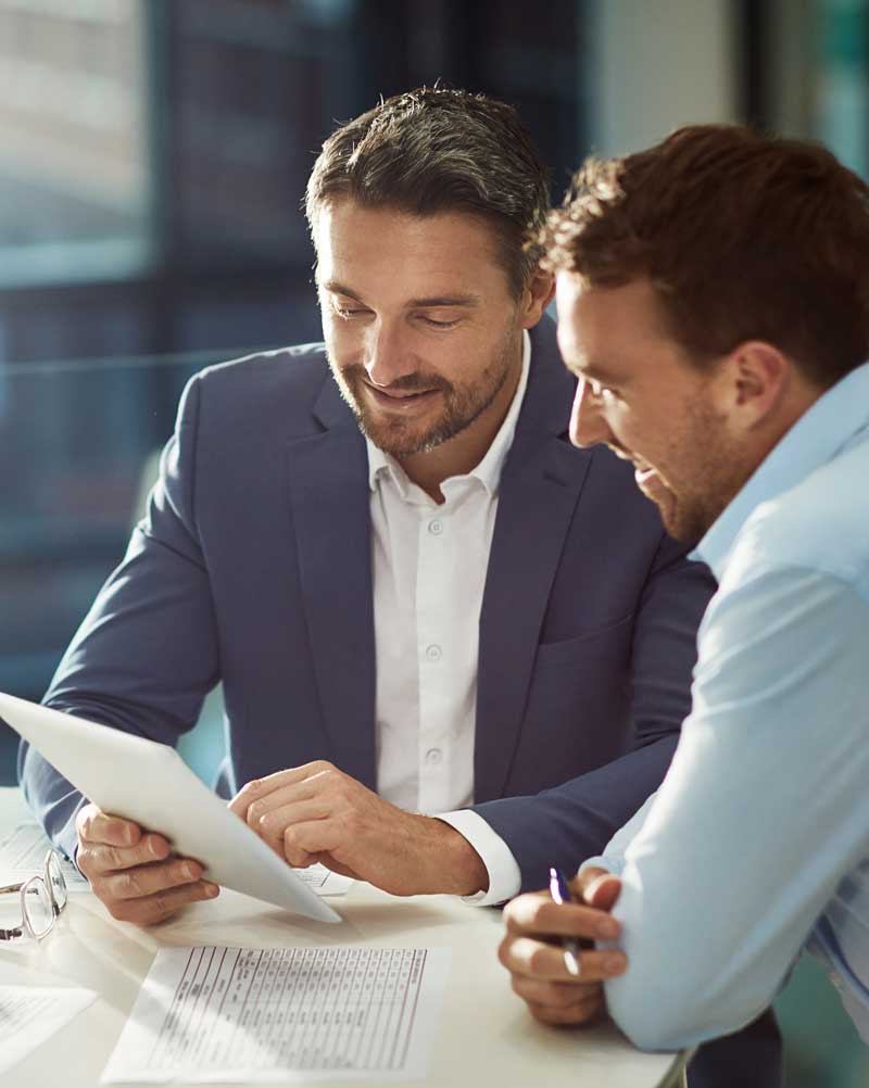 Two men setting up automations to prevent bottleneck